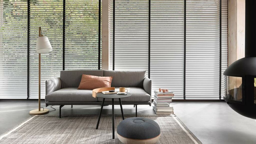 Modern and elegant living room with large windows, featuring Venetian Blinds by Luxaflex. 