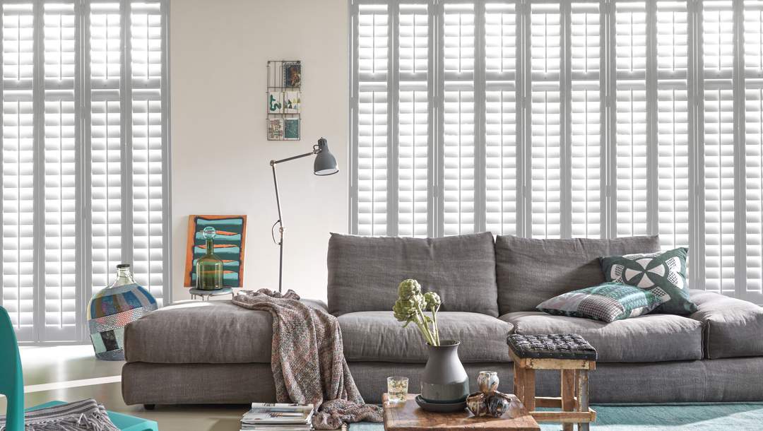 White Wood Shutters by Luxaflex in a bright and cozy living room