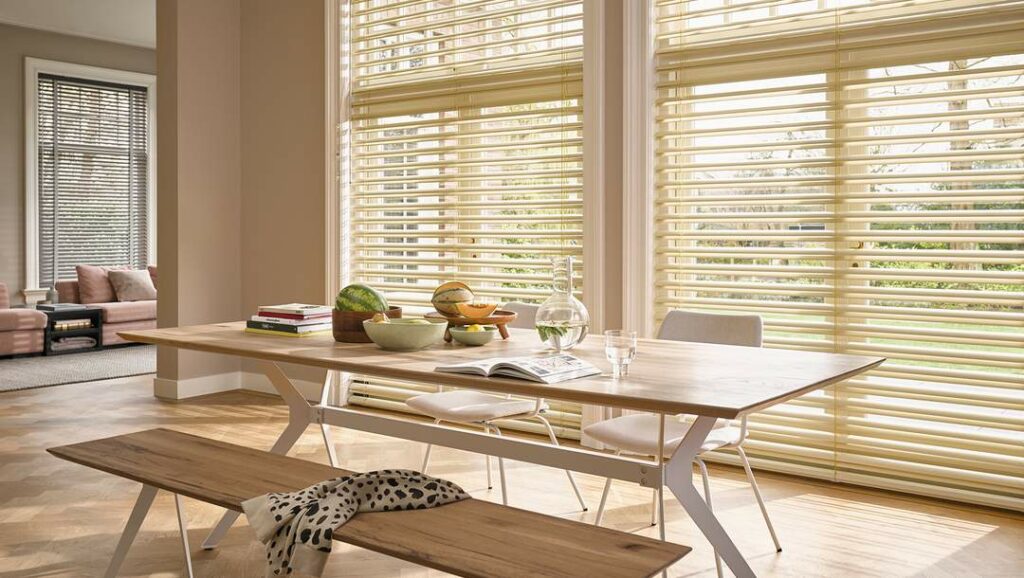 Warm, modern, and wooden living room featuring Yellow Venetian Blinds by Luxaflex, available at Complete Blinds showroom.