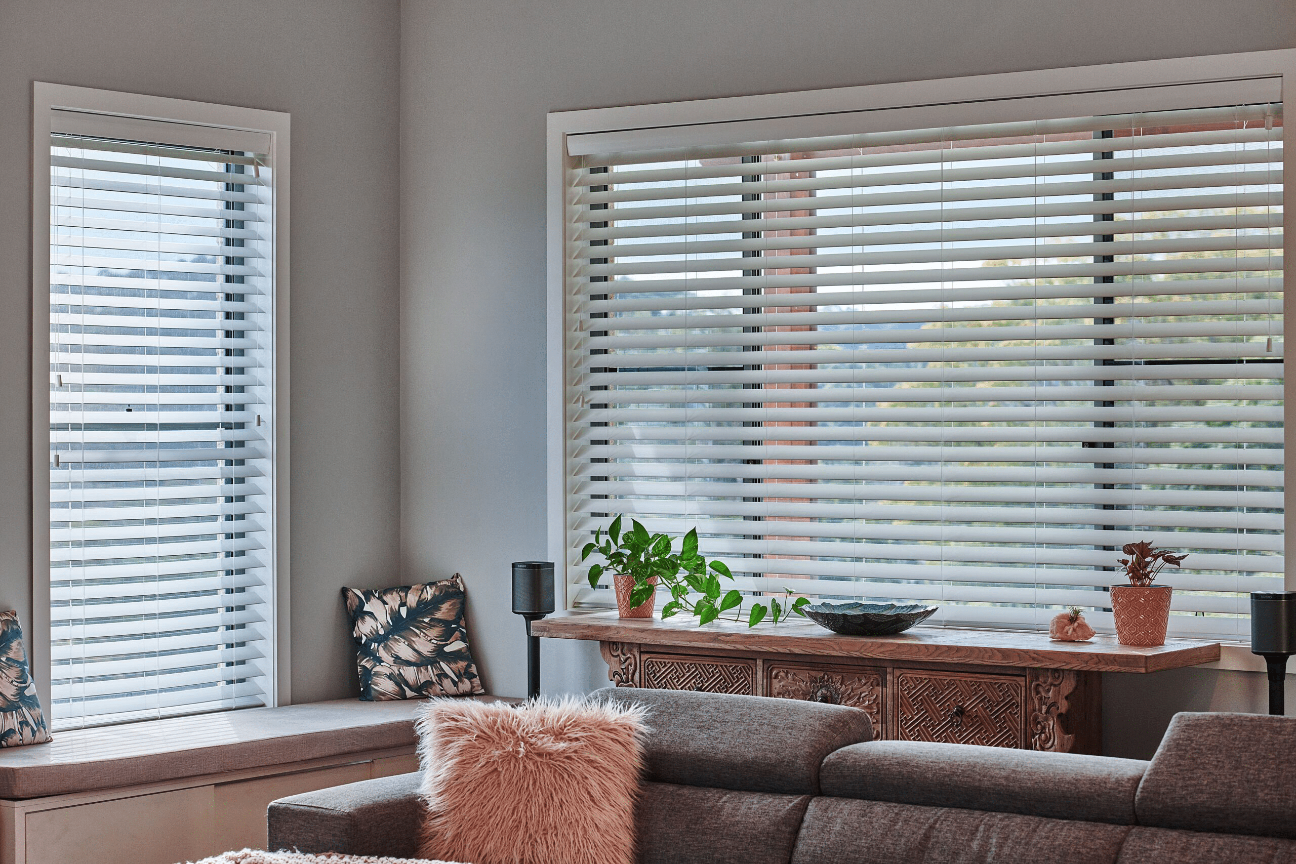 Smart privacy blinds with cord installed in a modern and simple living room.