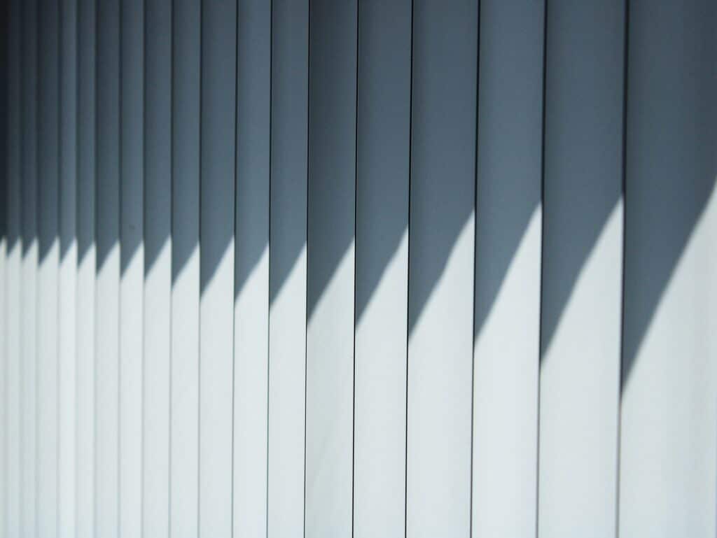 a close up of a wall with vertical blinds