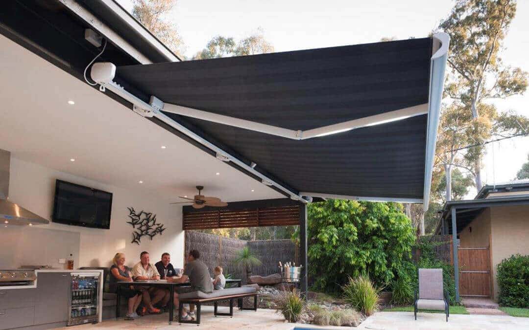 a patio with a black and white striped awning