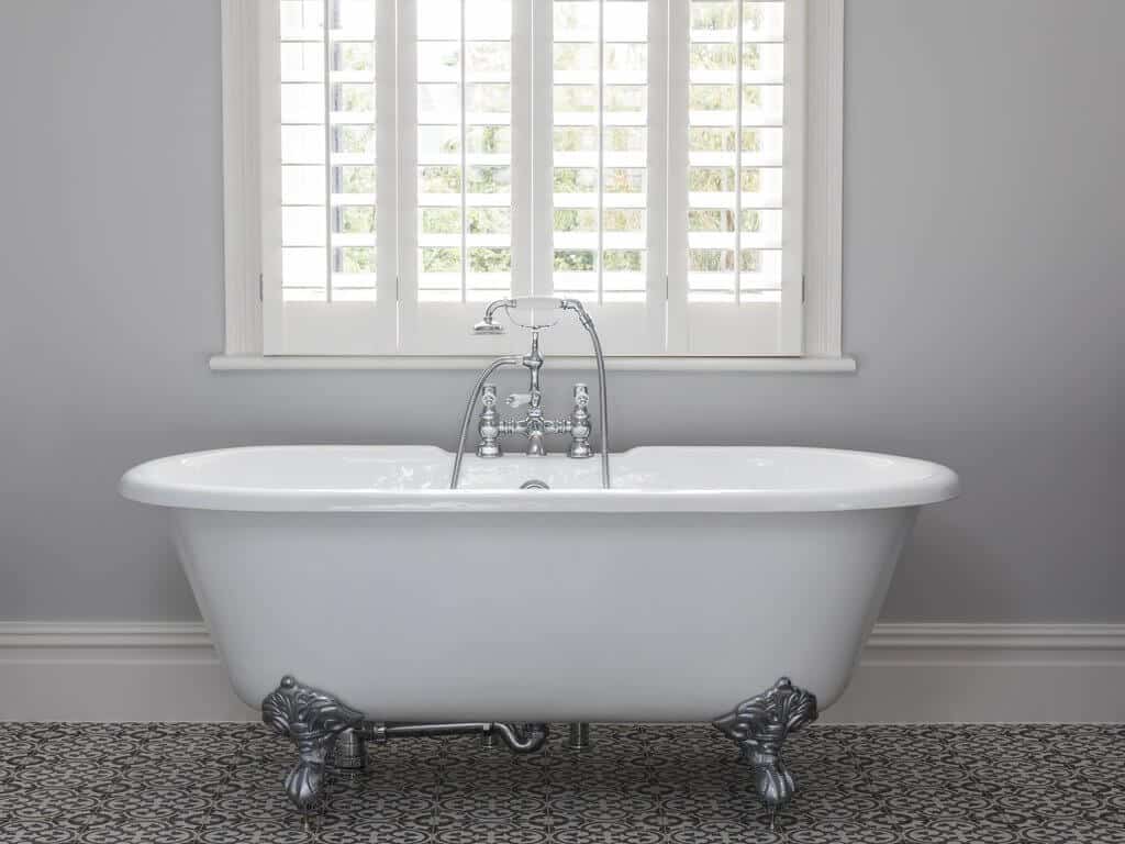 White Plantation Shutters installed in a white classical-themed bathroom. Perfect shutter option for your bathroom. 