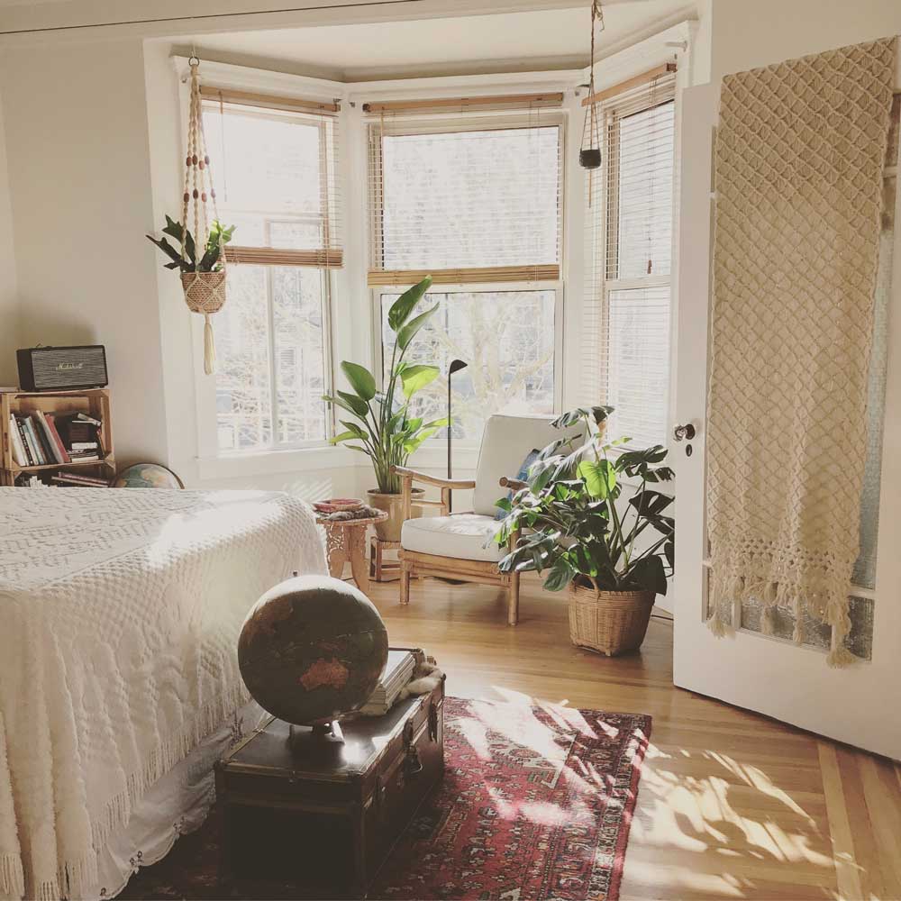 a bedroom with a bed, a rug, and a window