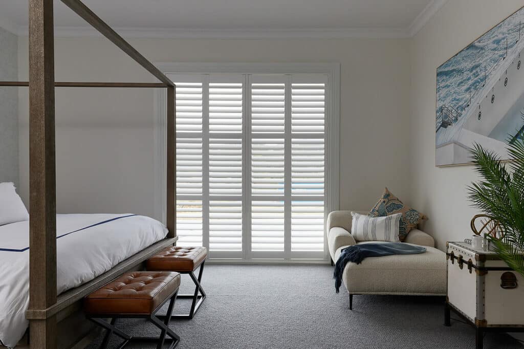 Plantation Shutters installed in a bedroom for cosy light ambient. By Complete Blinds.
