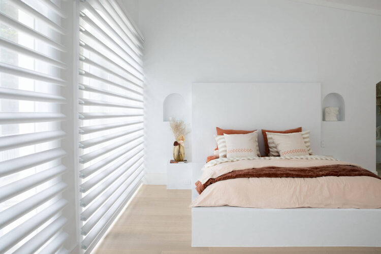 Pirouette Shades With Softly Curved Fabric Vanes Allowing Flexible Light Control And UV Protection Diffusing Light In A Cozy Bedroom. Innovative And Minimalist Design. For Sale At Complete Blinds Sydney.