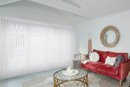 Southwestern Living Room Style With Red Couch And Luxaflex Luminette Privacy Sheers Covering A Large Window While Diffusing Natural Light To Brighten Up The Room.