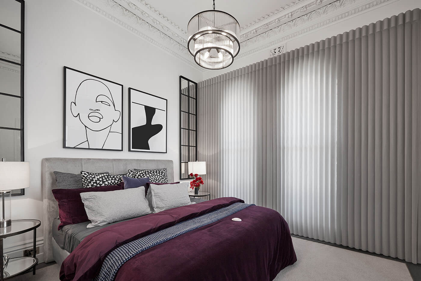 Contemporary bedroom design with purple bedding and line art on wall, featuring Luxaflex Luminette Sheers elegantly covering the room's windows.
