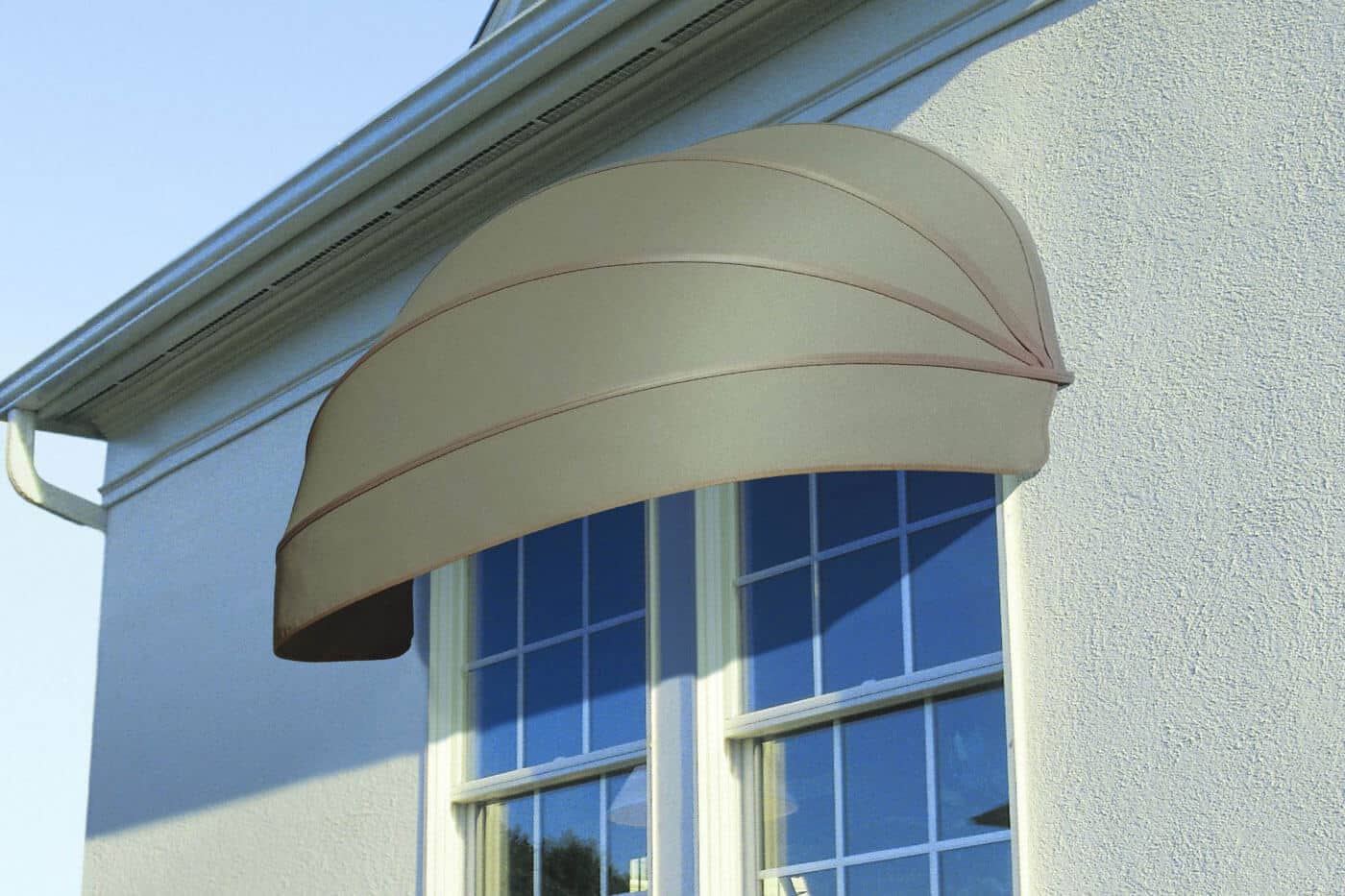 Outside view of a house window covered by Luxaflex Awnings, offering UV protection, available in various shapes and styles. Made in Australia.