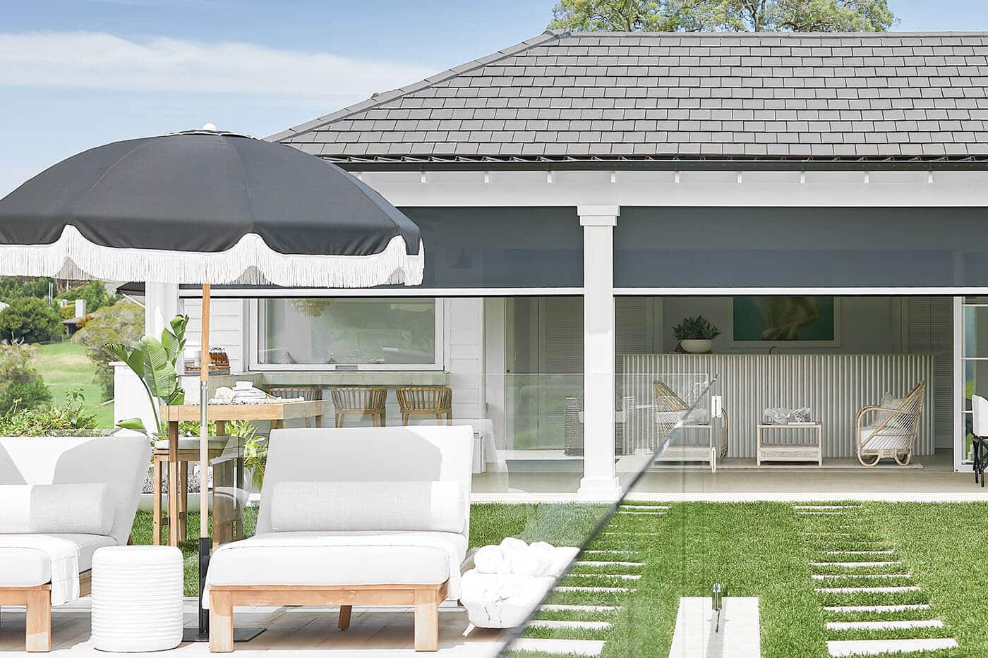 Outside view of a modern and elegant home with patio and a garden, featuring Luxaflex Magnatrack providing shades to the patio. On display in our Sydney showroom.