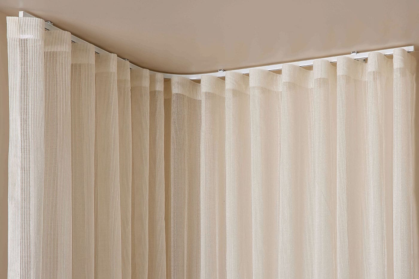 Beige colour Luxaflex curtains for ultimate privacy and natural light flow control. Available in various fabric designs, systems, and opacity. Available in Complete Blinds Sydney showroom.