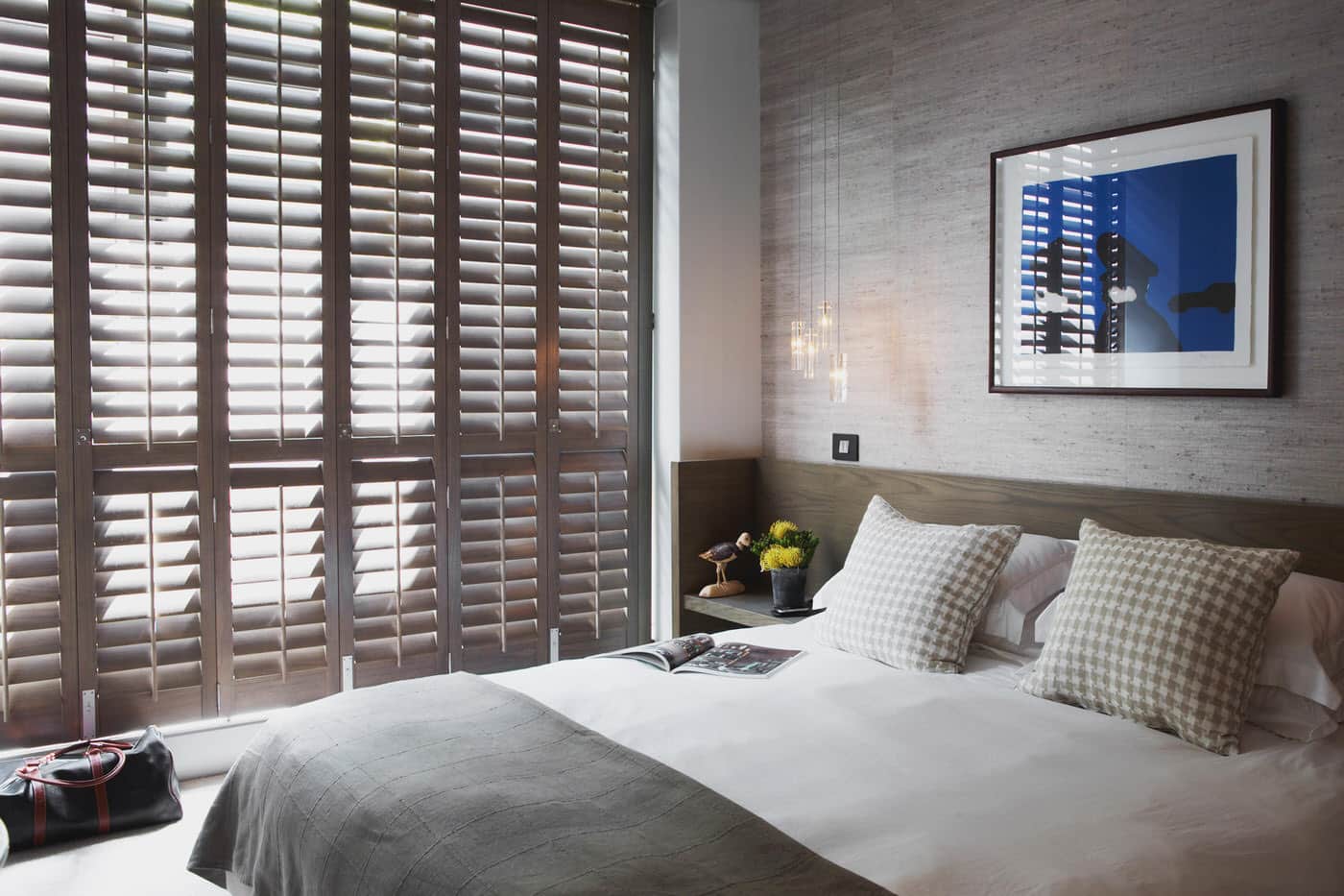 Brown Norman Normandy Shutters made from solid timber in a contemporary bedroom. For sale at Complete Blinds Sydney.