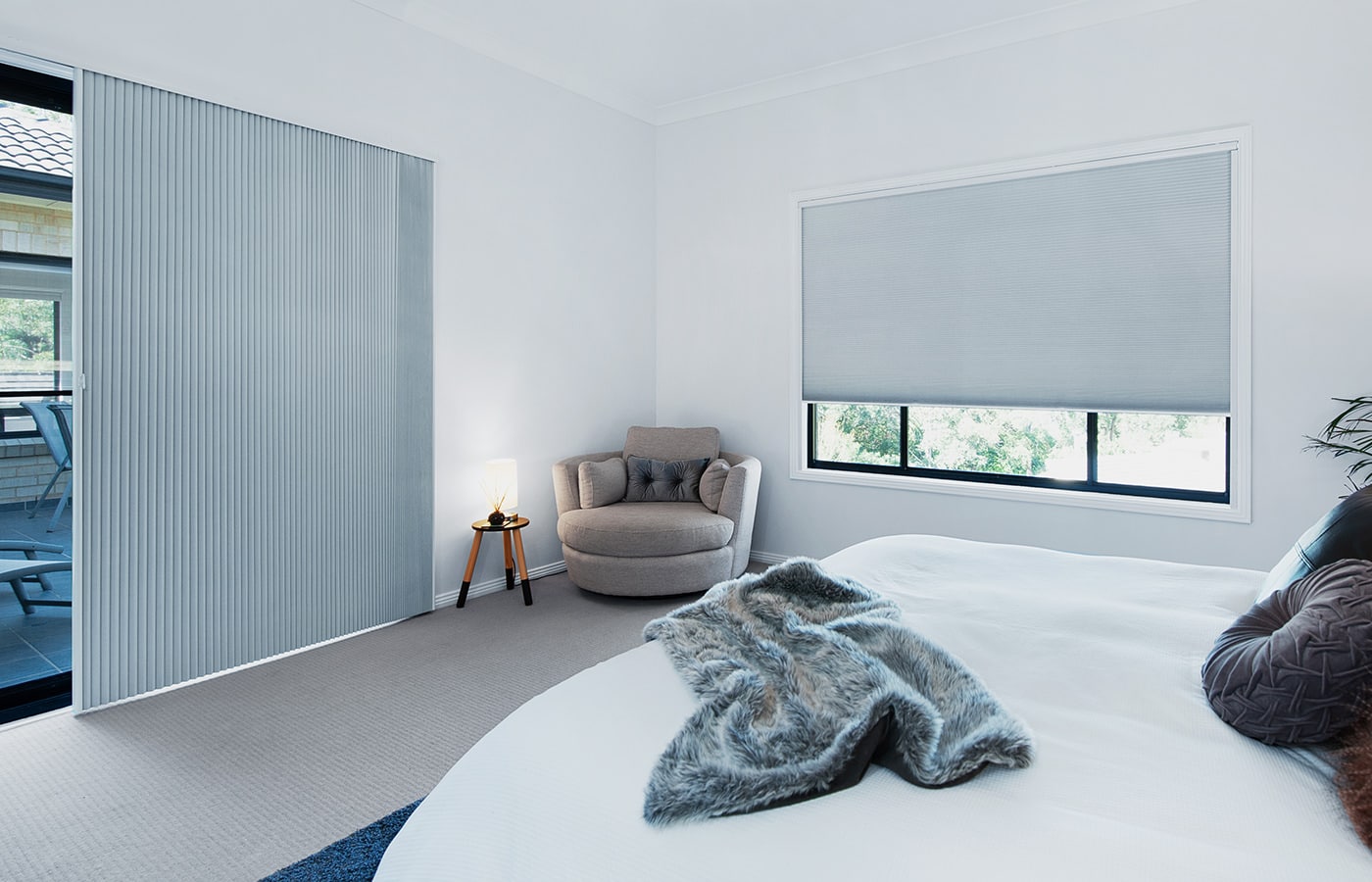 Elegant room with blueish tone and timeless furniture style, featuring Luxaflex award-winning design and industry-leading Honeycomb Shdes. Available in various styles, systems, and fabrics. For sale and on display in Complete Blinds Sydney showroom.