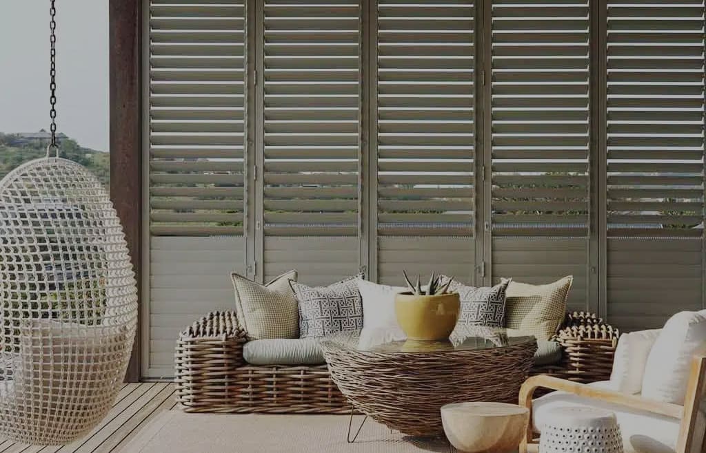 CW Vueline aluminium shutters in a eclectic-styled outdoor space/patio. Available in various panel arrangements. For sale in our Sydney showroom.