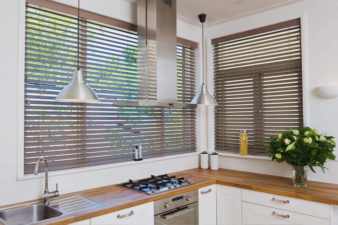 Modern farmhouse style kitchen featuring Timber Venetian Blinds by Norman filtering out sun light. On display in our Sydney showroom.