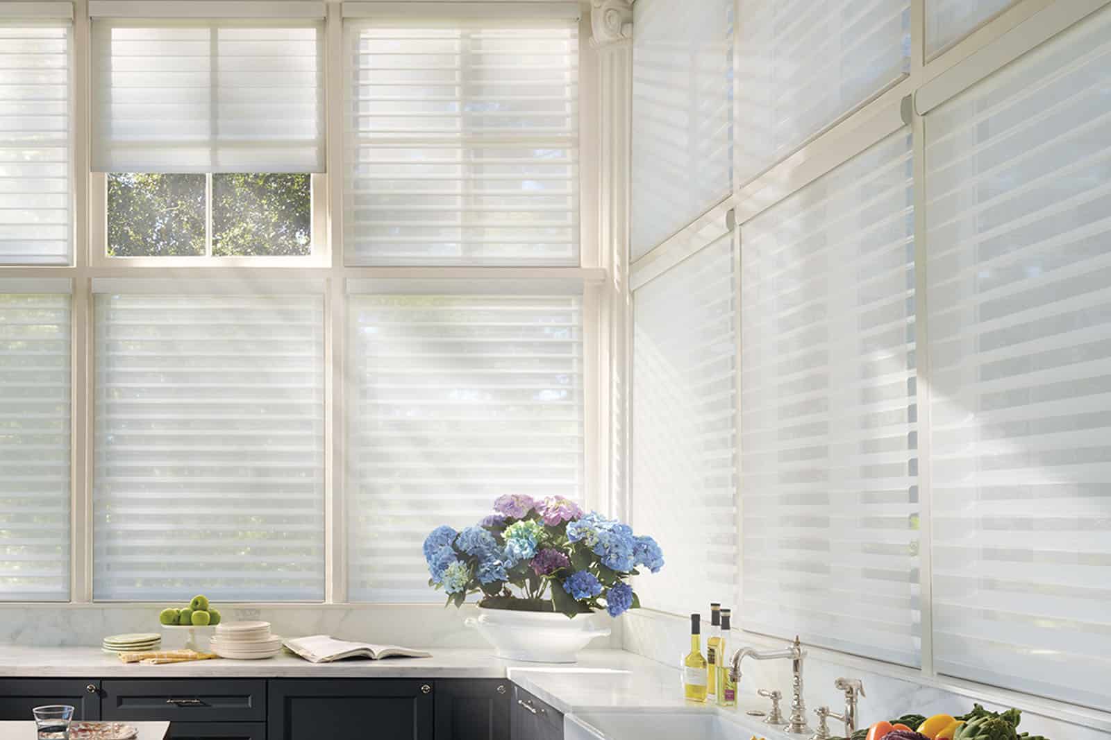 a kitchen with white blinds and a sink