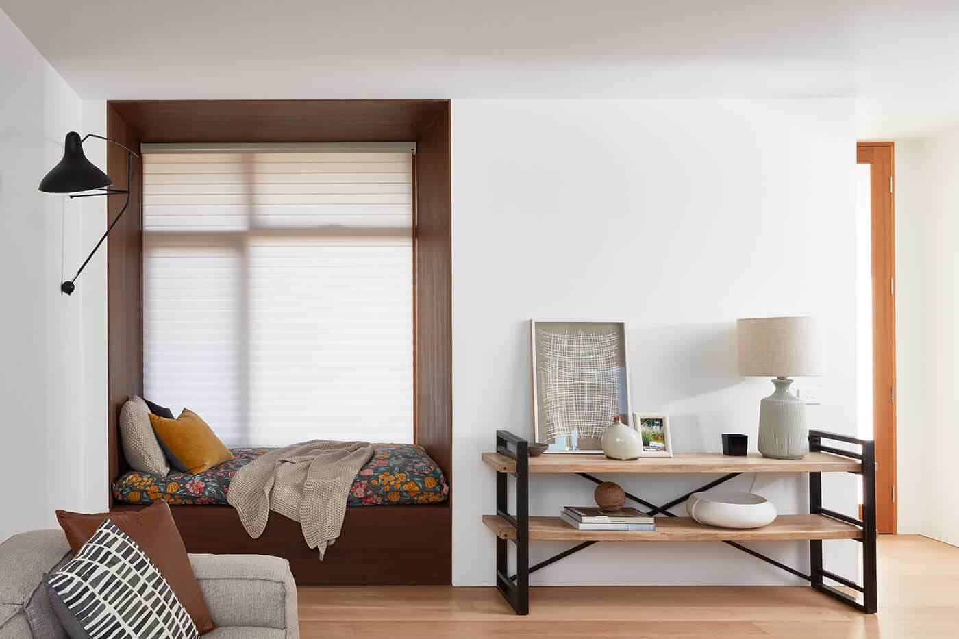 Cozy living room with wooden furniture and earthy tones, featuring Luxaflex Silhouette Shades by the window diffusing natural day light while offering UV protection. Available in Complete Blinds Sydney.