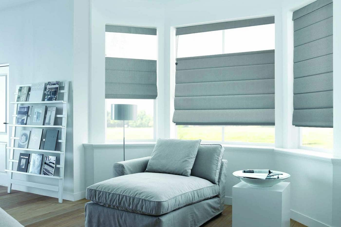 Elegant contemporary white-themed house space with windows covered by Luxaflex top-down Roman Blinds. Available in various fabrics, sizes, and opacity. For sale in Complete Blinds showroom.