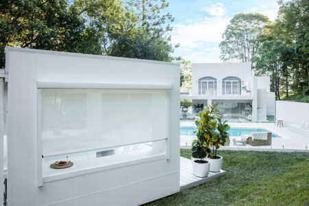 Modern White Luxurious Home With Outdoor Swimming Pool And Garden, Featuring Norman Evo Awnings.