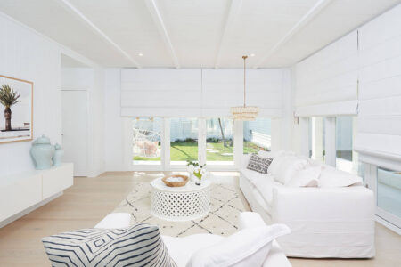 Large White Contemporary House Space With Wooden Floors And Large Window Panes Covered By White Roman Blinds By Luxaflex. Made In Australia.