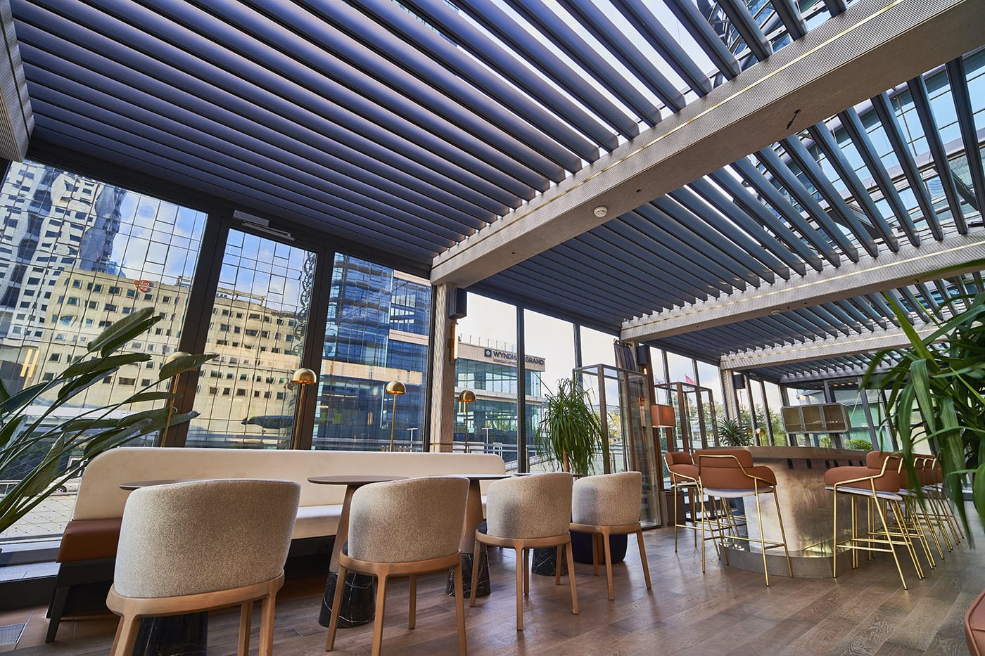 Commercial pergola dining area installed with Luxaflex Retractable Awnings.