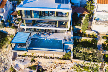 Bird's Eye View Of Modern Luxurious Home With Swimming Pool, Installed With Luxaflex Motorised Awnings.