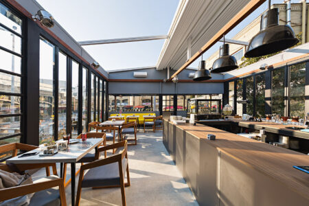 Commercial Pergola Dining Space Installed With Palmiye Fabric Retractable Awnings By Luxaflex.