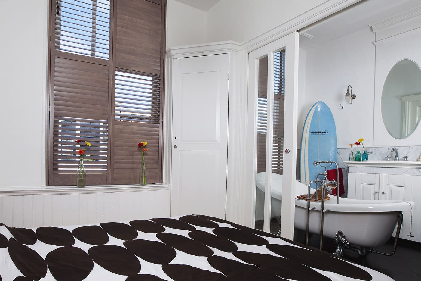Eclectic themed bedroom and toilet installed with brown Norman Normandy Shutters.
