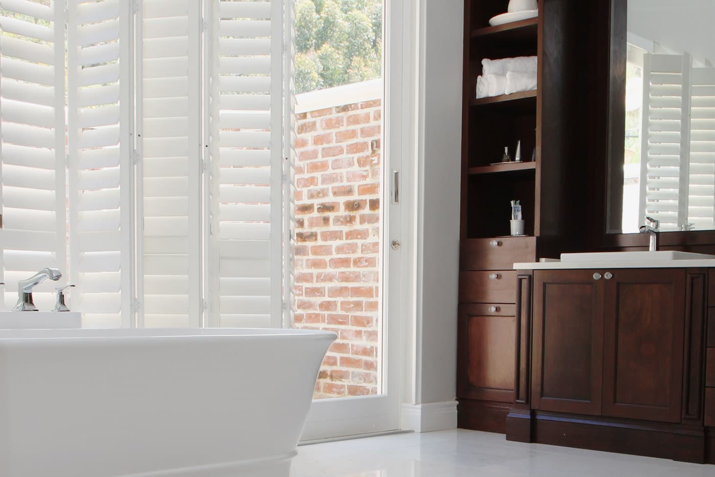 Norman Woodlore Plus Shutters installed in a modern and simple bathroom.