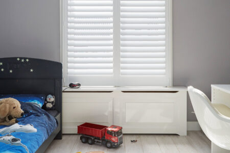Cozy Grey And White Kids Room With Toys On The Floor, Featuring White Woodlore Shutters By Norman.