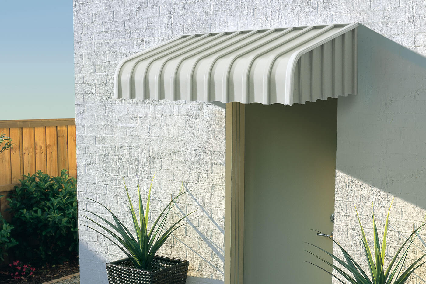 Home back door covered with Luxaflex Aluminium Fxed Awnings. Available in various colours.