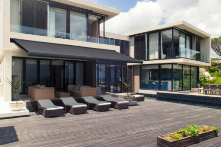 Modern Contemporary Black And Beige Home Patio Featuring Black Folding Arm Awning By Luxaflex.