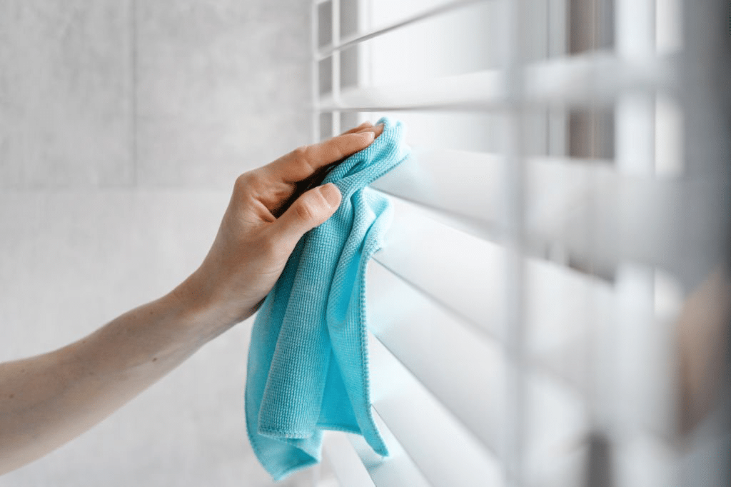Wiping window shutters with dry cloth. Guide on cleaning plantation shutters.